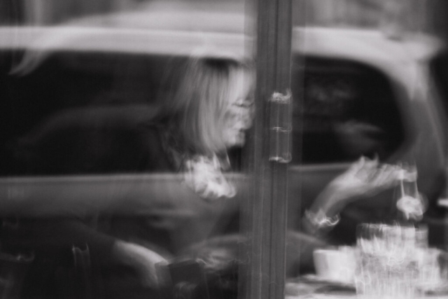 Black and white photo street photography Paris woman with coffee